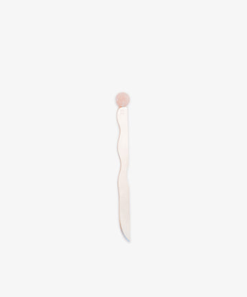 The Letter Opener is a wavy, flat, silver-plated tool featuring a round pink handle, shown standing upright against a plain white background.