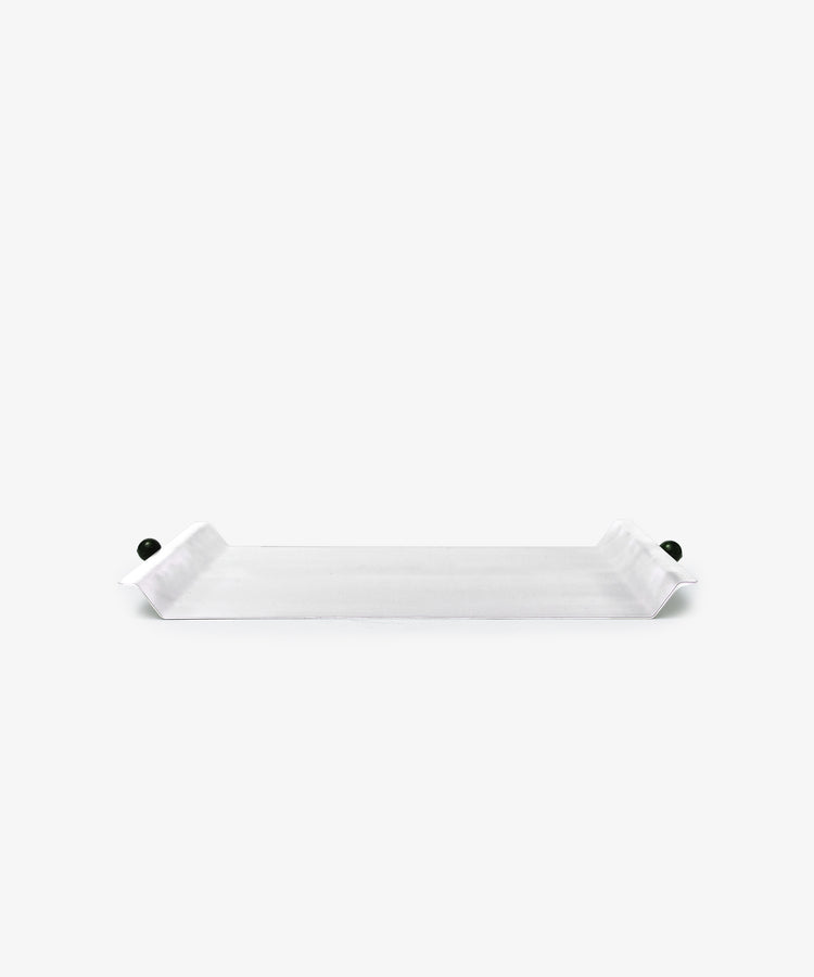 The Roberta Serving Tray is rectangular and white with upturned ends and small round dark side knobs, featuring a minimal design against a plain white background.