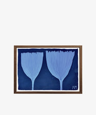 Blue Tulips is a framed botanical artwork featuring two abstract, light blue leaf shapes on a dark blue background with the initials NM in the corner—an evocative piece from the Field Studies collection.