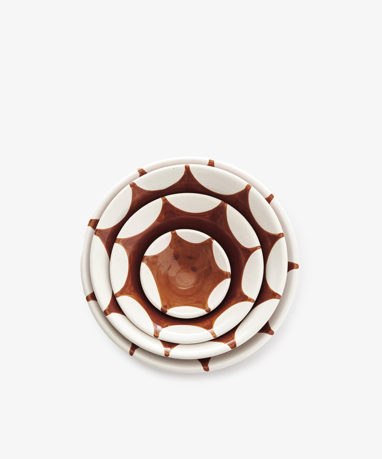 The Stella Nesting Bowls set includes three handmade bowls with a brown and white geometric pattern—ideal as mismatched aperitivo snack bowls for your next gathering.
