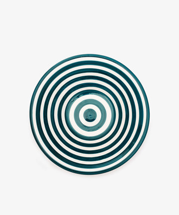 The Natalia Serving Bowl is a unique handmade piece with concentric dark teal stripes on a white background, shown from above.