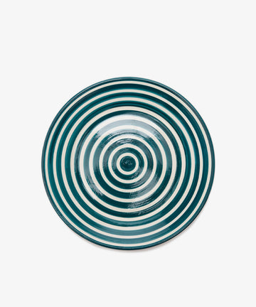 The Natalia Serving Bowl, featuring handmade charm with concentric green and white rings, is showcased against a plain white background.