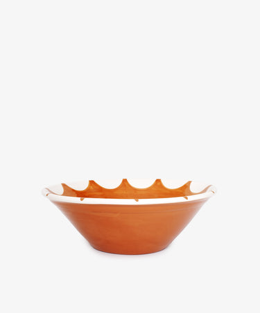 The Stella Serving Bowl is a brown ceramic bowl with a wide, shallow shape and a white star design near the rim, shown against a plain white background.
