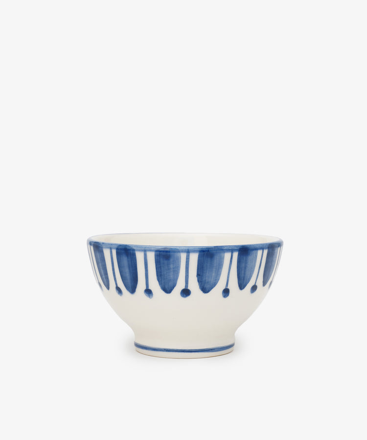 The Jorge Cereal Bowl, Set of 4 features elegant blue and white designs with a splash of blue paint—perfect Portuguese-inspired bowls for serving cereal or displaying vibrant dishes.