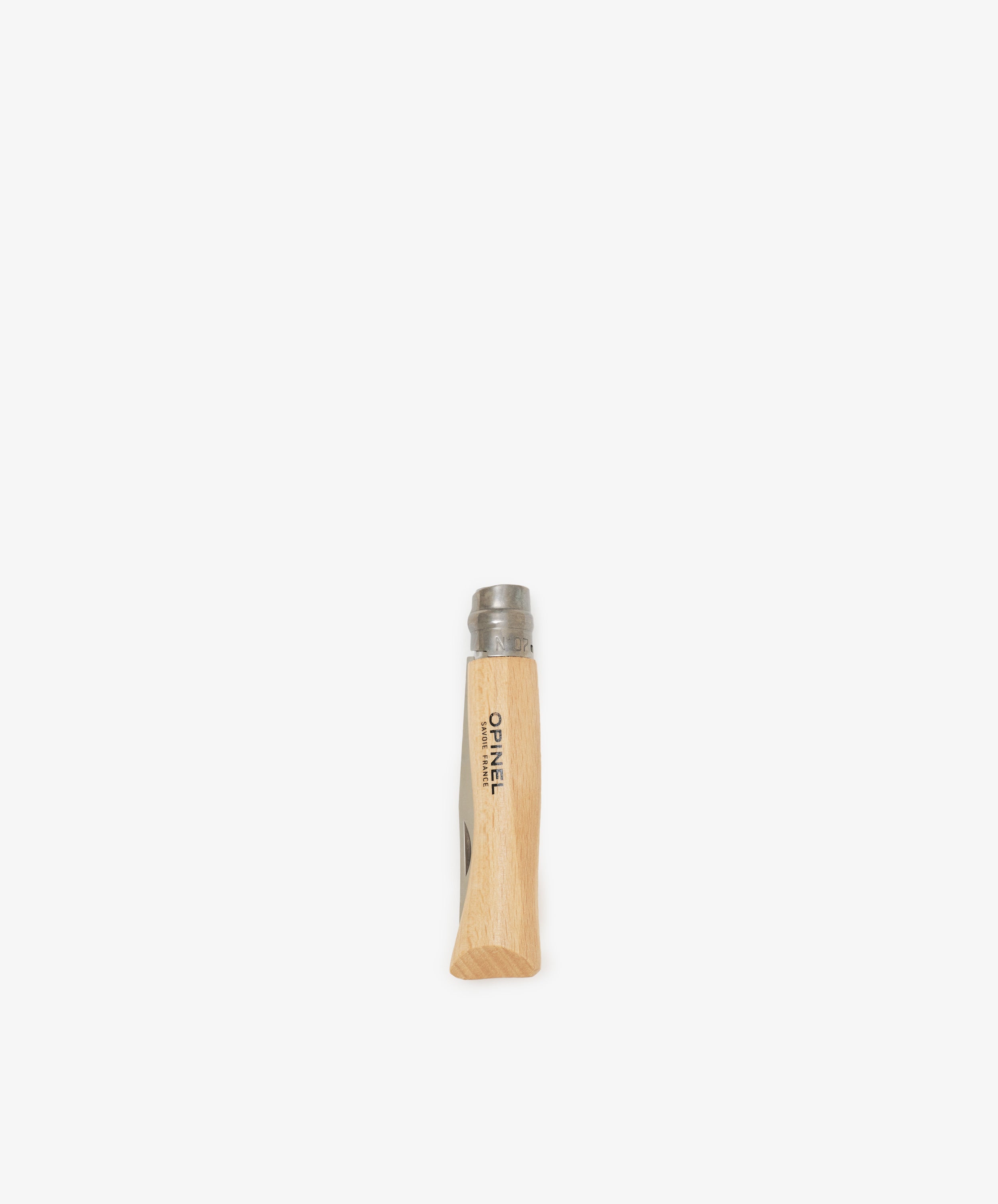 The Primo Kids Knife, a closed French folding knife with a wooden handle and metal top, stands upright on a plain white background.