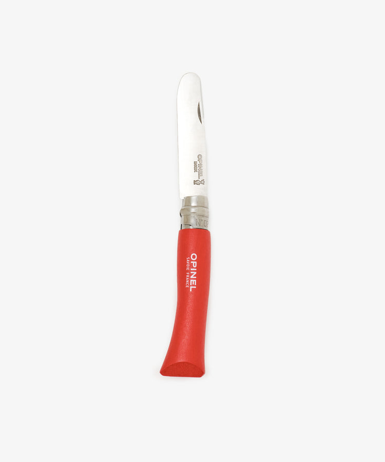 The Primo Kids Knife is a classic French folding knife featuring a rounded stainless steel blade and a red wooden handle, ideal as a beginner’s outdoor carving tool.