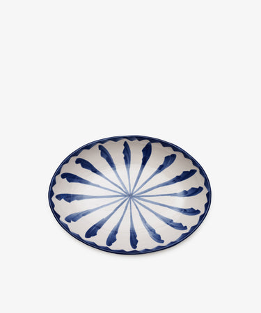Rayas Oval Serving Platter, handmade from ceramic with a white base and vibrant blue radial brushstroke pattern, shown from above on a plain white background.
