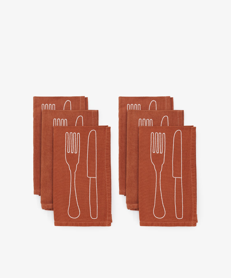 Fourchette & Couteau Napkins. Two stacks of three napkins in terracotta linen with white knife and fork stitching