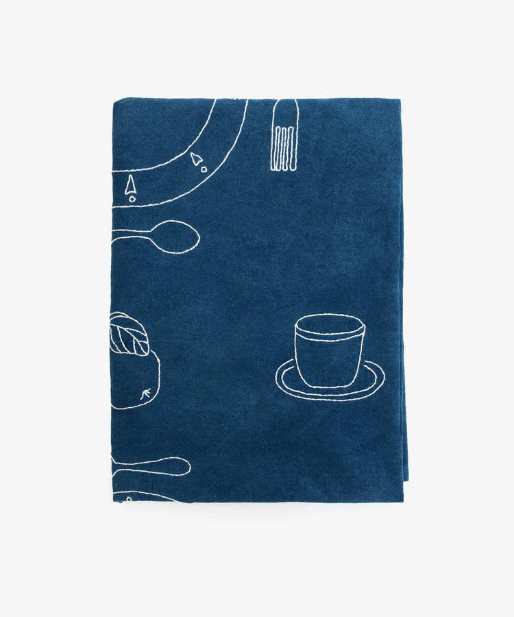 Dîner d'Eté custom tablecloth by Oeuvres Sensibiles. Indigo dyed linen cloth embroidered with white thread.