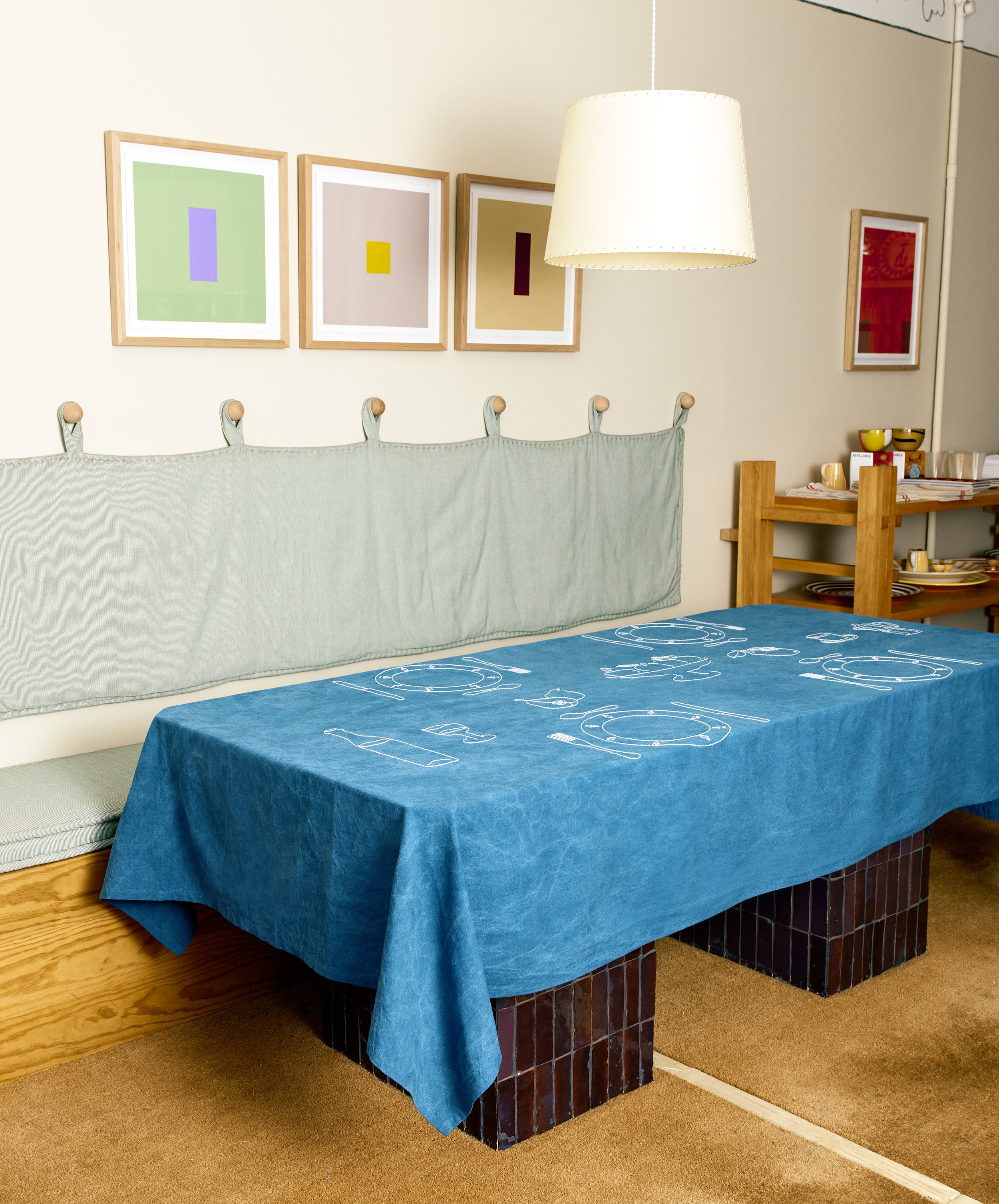 Full room view of Dîner d'Eté tablecloth in indigo linen spread across a table.