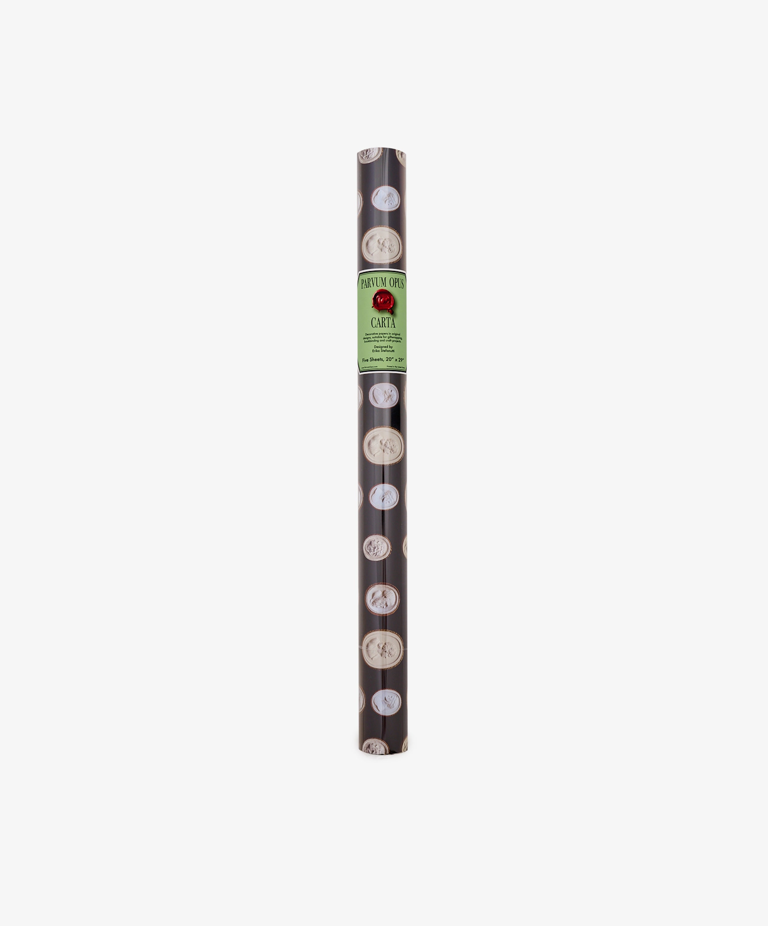 A roll of Intaglio Gift Wrap featuring black paper with circular white designs and a green label reading CARTI at the top center, perfect for presenting Grand Tour gifts in style.