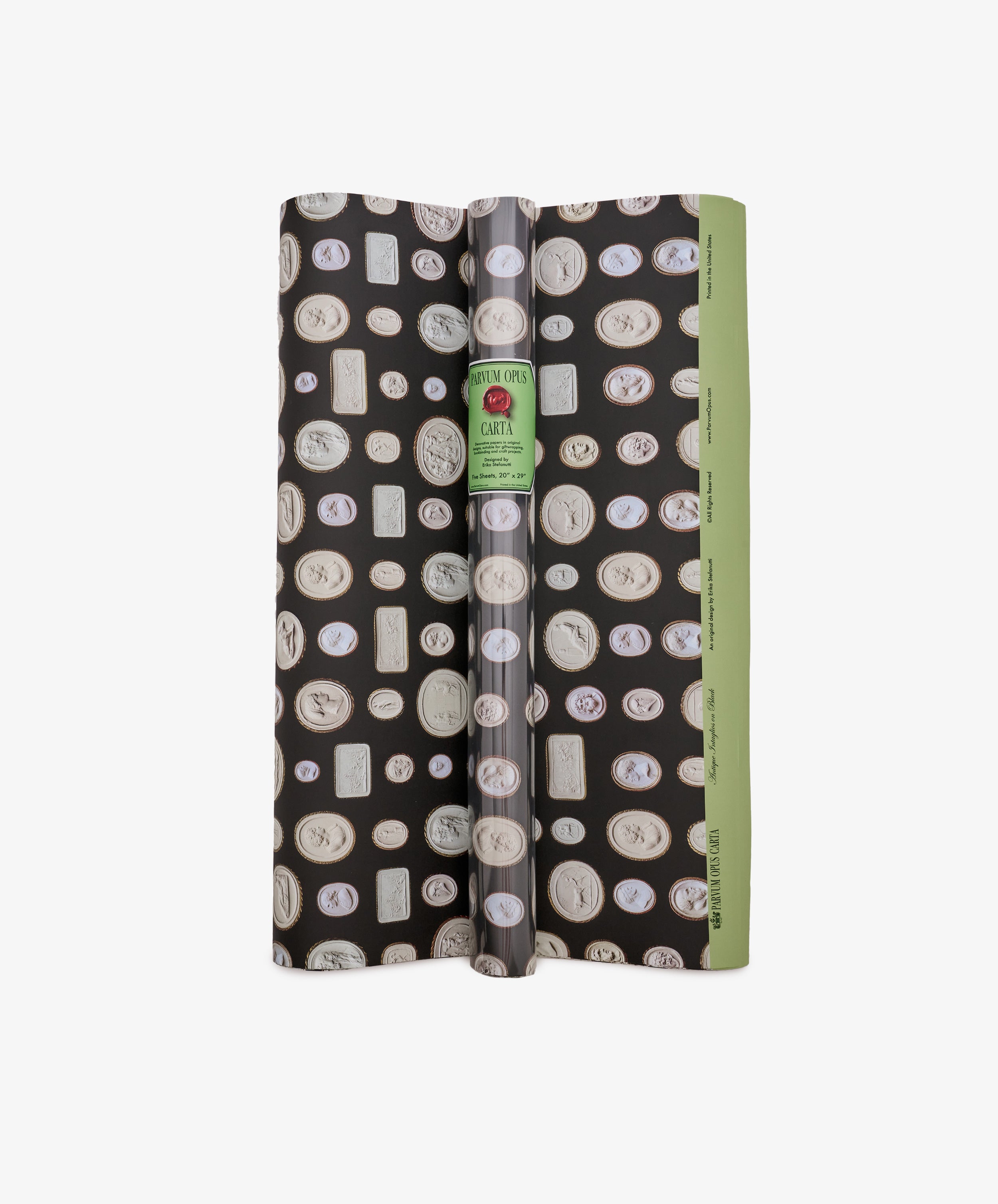 A roll of Intaglio Gift Wrap featuring a black and green design with assorted cameo-style medallions inspired by engraved gems, finished with a white label reading Carter—perfect for Grand Tour gifts.