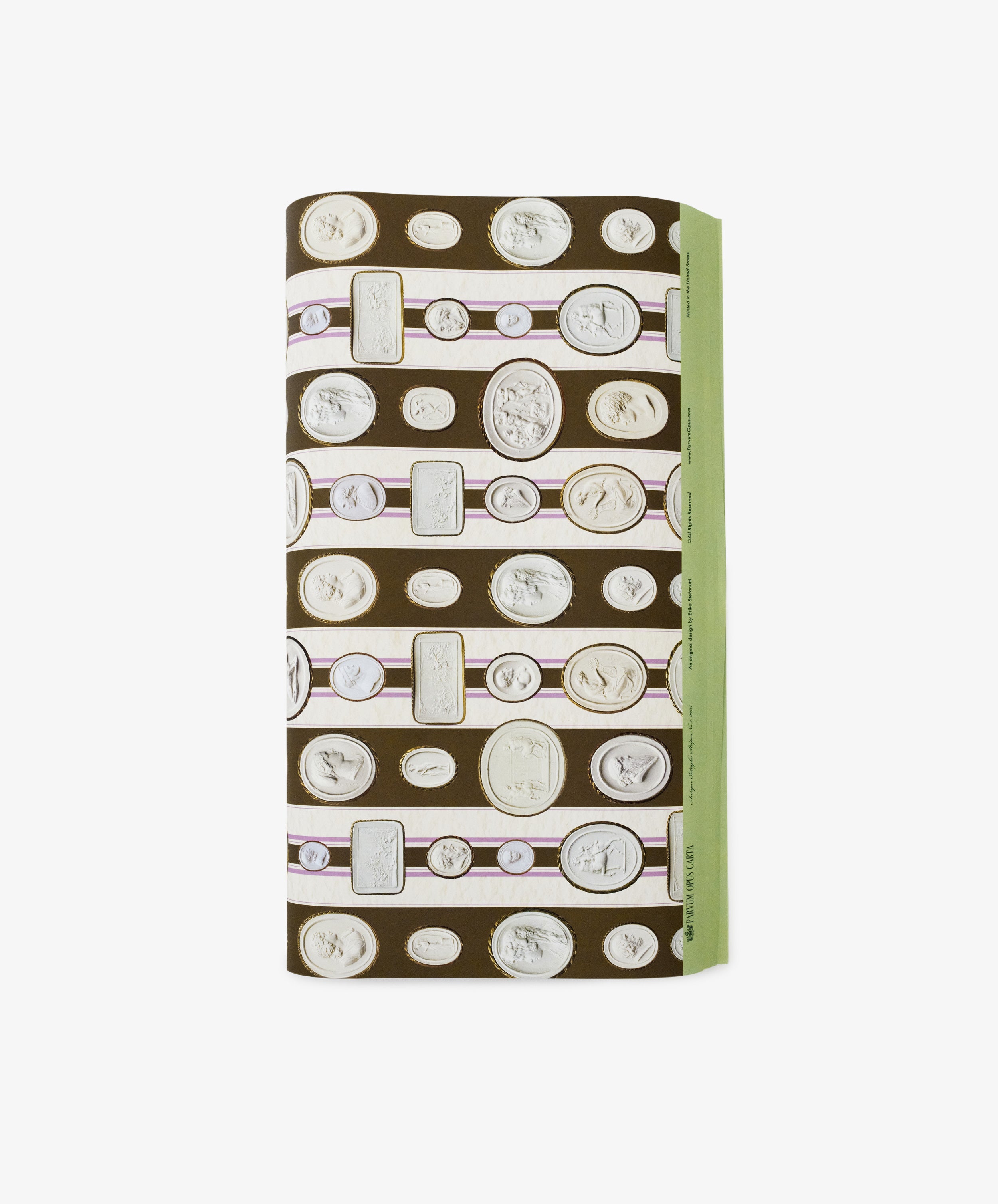 A folded rectangular Intaglio Stripe Gift Wrap featuring classical coin and cameo designs on a brown background with a green edge—perfect for neoclassical gifts from Parvum Opus.