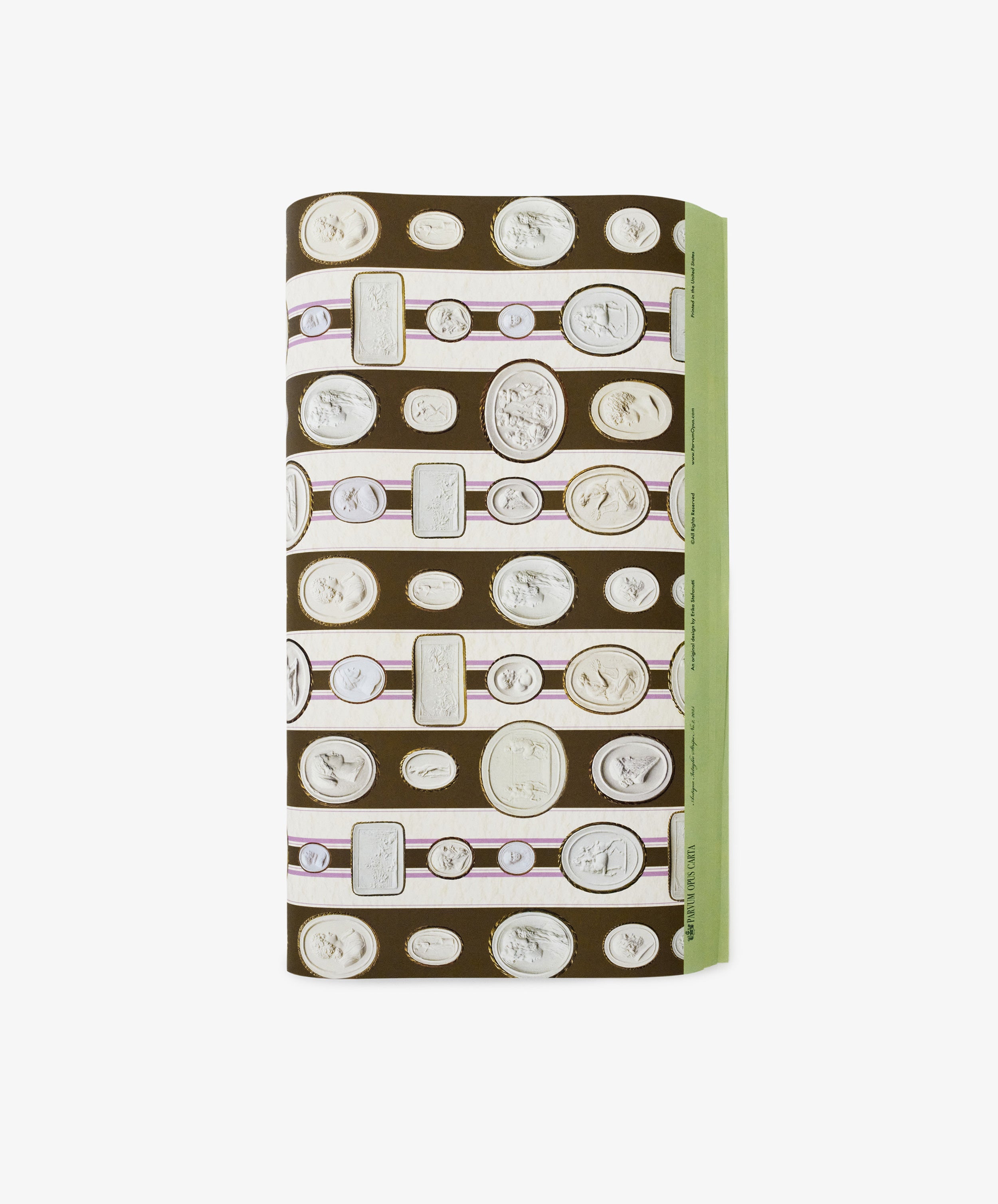 A folded rectangular object wrapped in Intaglio Stripe Gift Wrap, featuring horizontal rows of cameo and coin illustrations and a green edge on the right side.