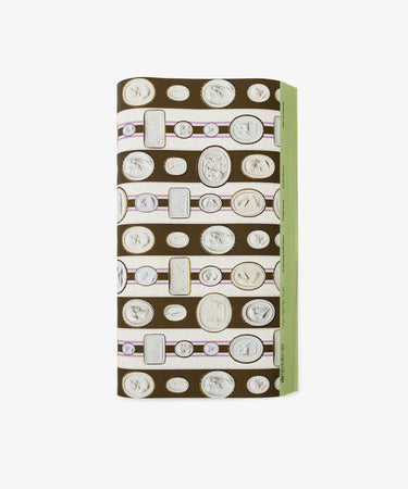 A folded rectangular object wrapped in Intaglio Stripe Gift Wrap, featuring horizontal rows of cameo and coin illustrations and a green edge on the right side.