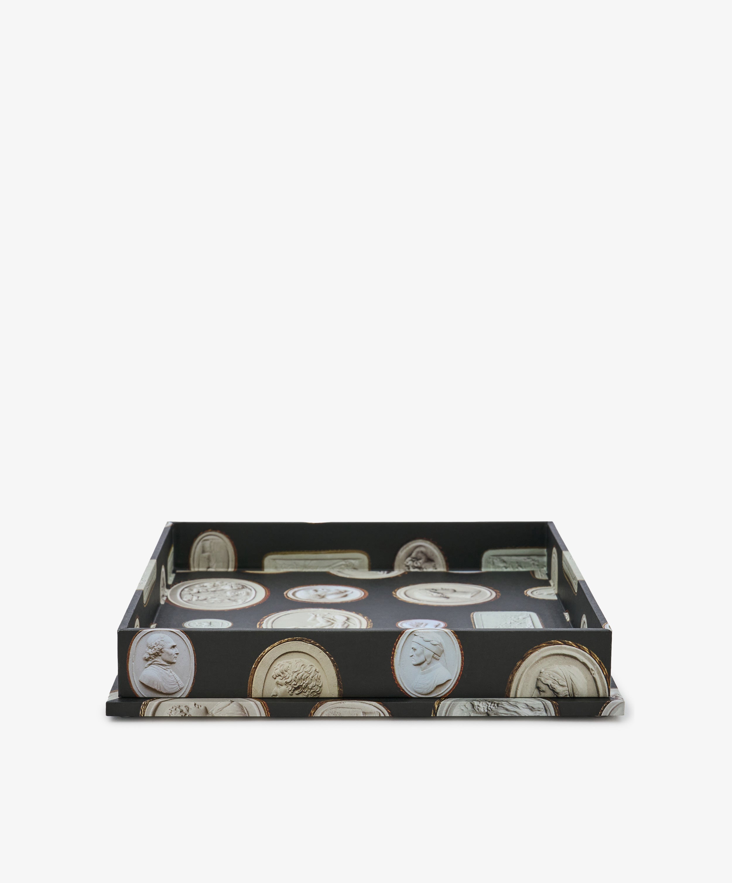Intaglio Nesting Tray featuring a black base adorned with classical cameo portrait images, expertly crafted from sturdy archival book boards and shown against a white background—a shallow tray ideal for use as a stylish desk organizer.