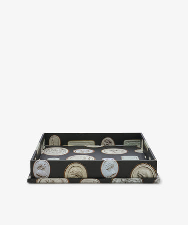 Intaglio Nesting Tray featuring a black base adorned with classical cameo portrait images, expertly crafted from sturdy archival book boards and shown against a white background—a shallow tray ideal for use as a stylish desk organizer.