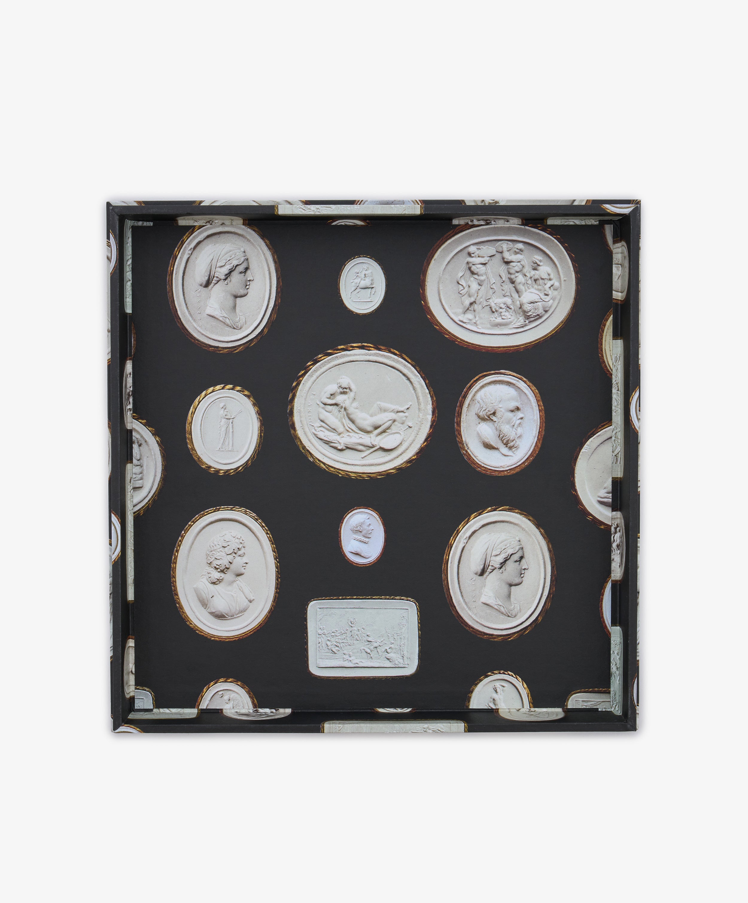 Introducing the Intaglio Nesting Tray: a shallow square organizer crafted from durable archival book boards, featuring a sophisticated black background adorned with oval and rectangular classical cameo motifs in white relief, and elegantly bordered with gold or brown accents. This stylish piece brings timeless elegance to your workspace.