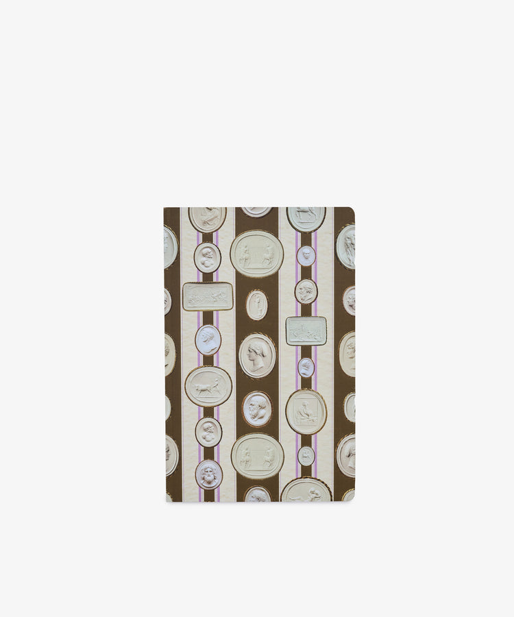 The Intaglio Notebook features a cover adorned with oval and round cameo-style portrait frames set against brown and beige stripes with purple accents, and is crafted with acid-free writing paper to preserve your notes and sketches.