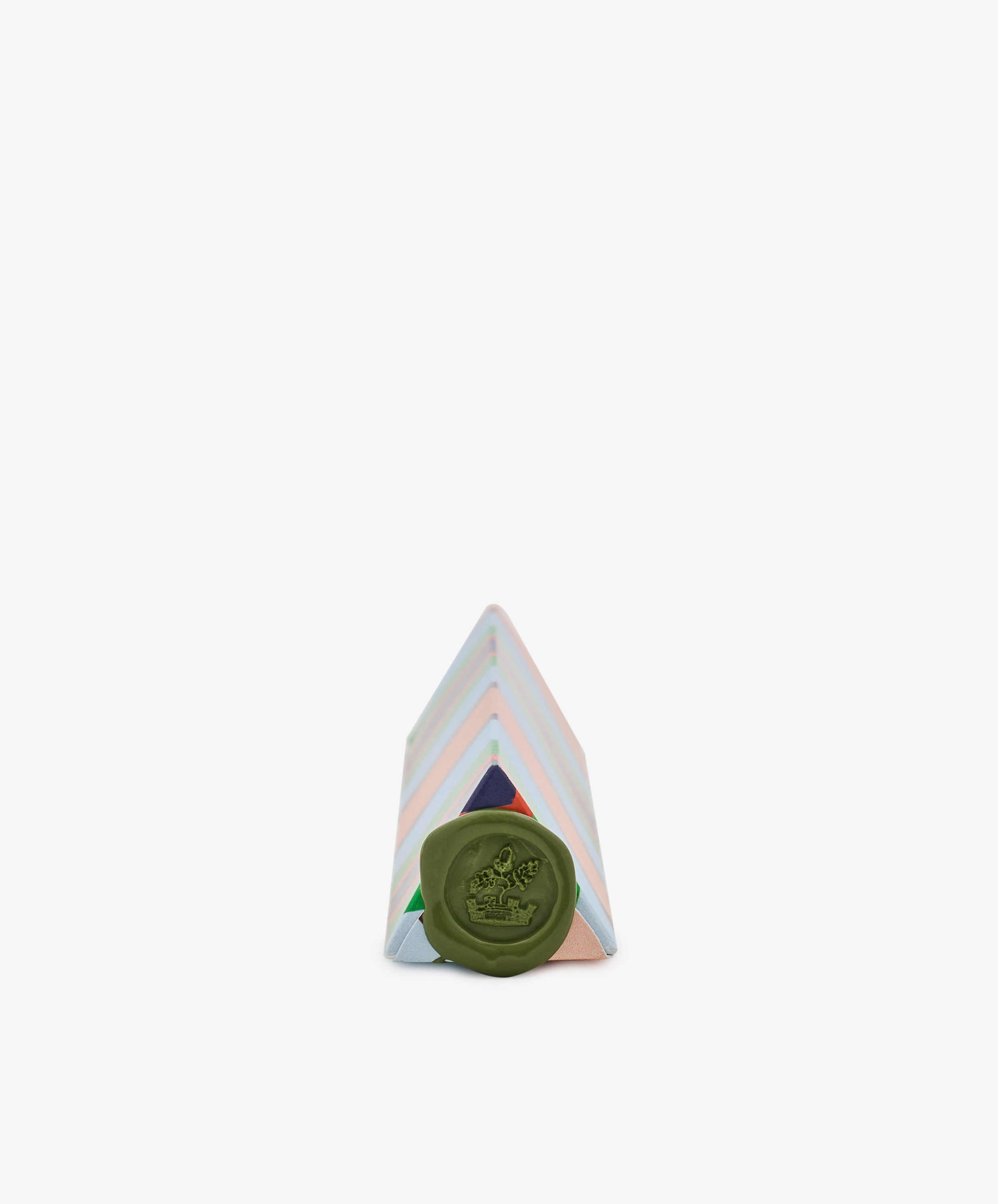 A Pencil Kit packaged in a pastel-striped triangular box with a green wax seal on the front, crafted from hand-marbled paper, placed against a plain white background.