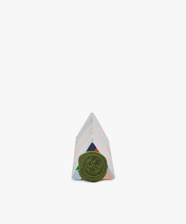 A Pencil Kit packaged in a pastel-striped triangular box with a green wax seal on the front, crafted from hand-marbled paper, placed against a plain white background.