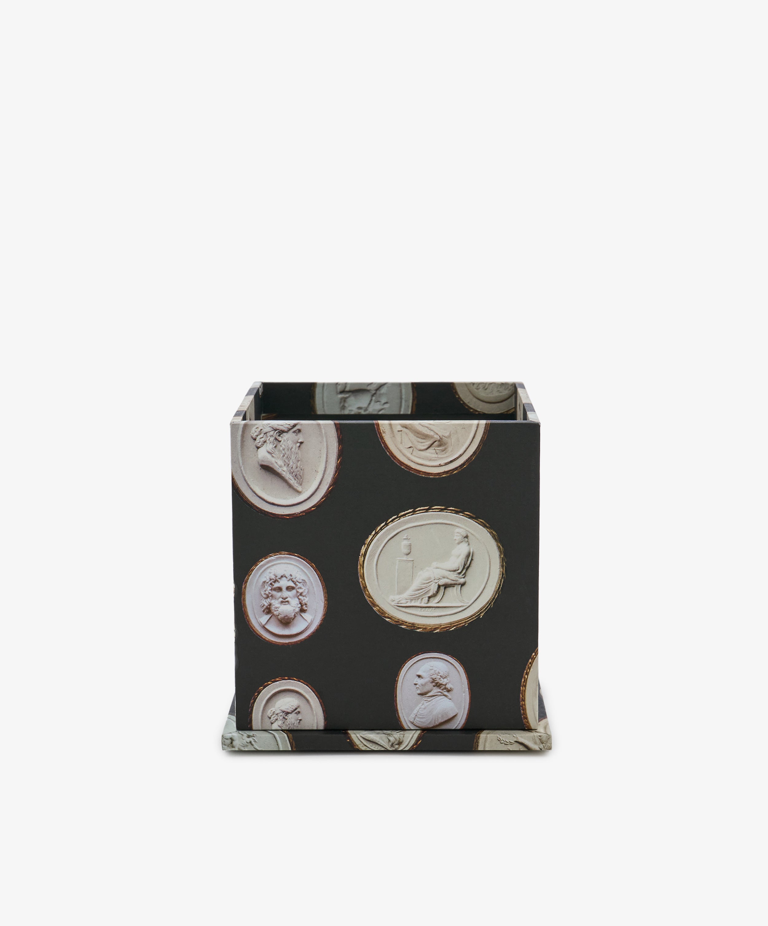 Introducing the Intaglio Pencil Pot: a square black desk pencil holder adorned with classical cameo-style medallion patterns in soft, light hues on every side, set against a crisp white backdrop. This weighted desk organizer brings both elegant style and reliable stability to your workspace.