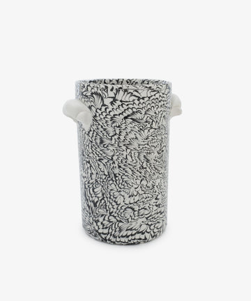 The Celine Wine Cooler is a tall, cylindrical ceramic piece featuring black and white feather-like clay patterns and two small white handles on each side.