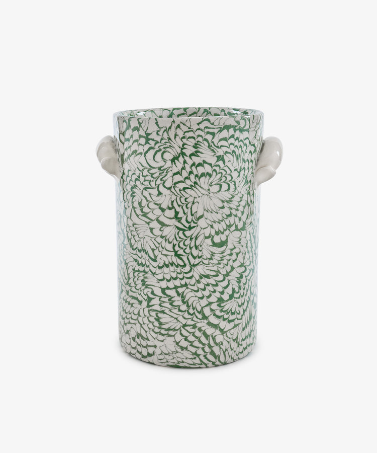 The Celine Wine Cooler is a cylindrical ceramic vessel with two small side handles, adorned with a dense green and white floral pattern on a white background that evokes the look of marbled ceramic artistry.