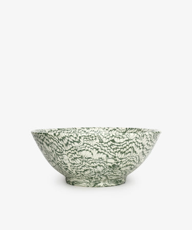 The Celine Salad Bowl is a handcrafted ceramic bowl featuring an intricate green and white floral pattern, set against a plain white background.