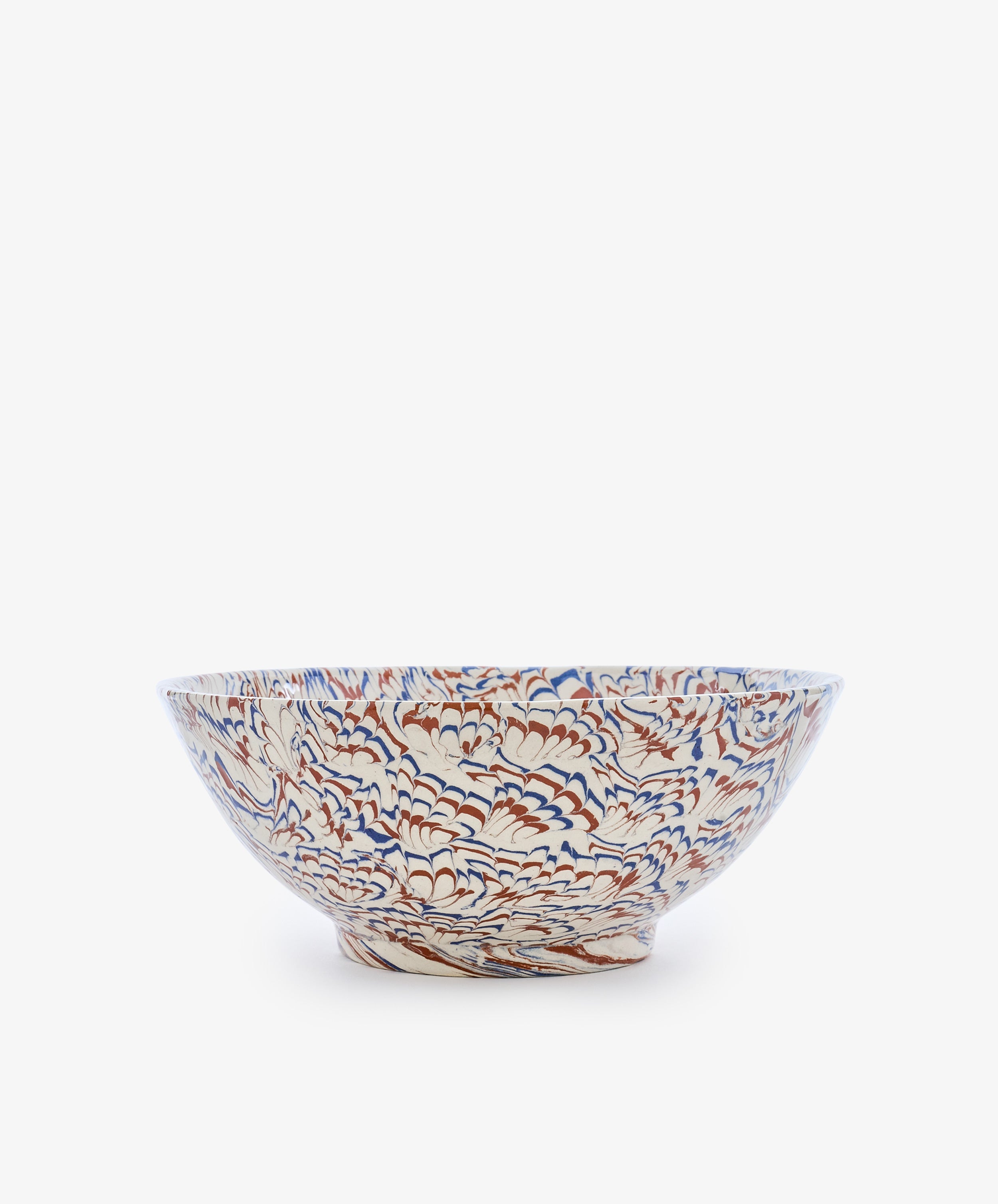 The Celine Salad Bowl is a ceramic salad bowl with a wide rim, showcasing an intricate floral pattern in blue, orange, and beige tones against a white background, beautifully reminiscent of marbled ceramic Agateware.