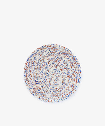 A round marbled ceramic Celine Salad Bowl featuring a swirling abstract pattern in blue, orange, and white on a plain white background.