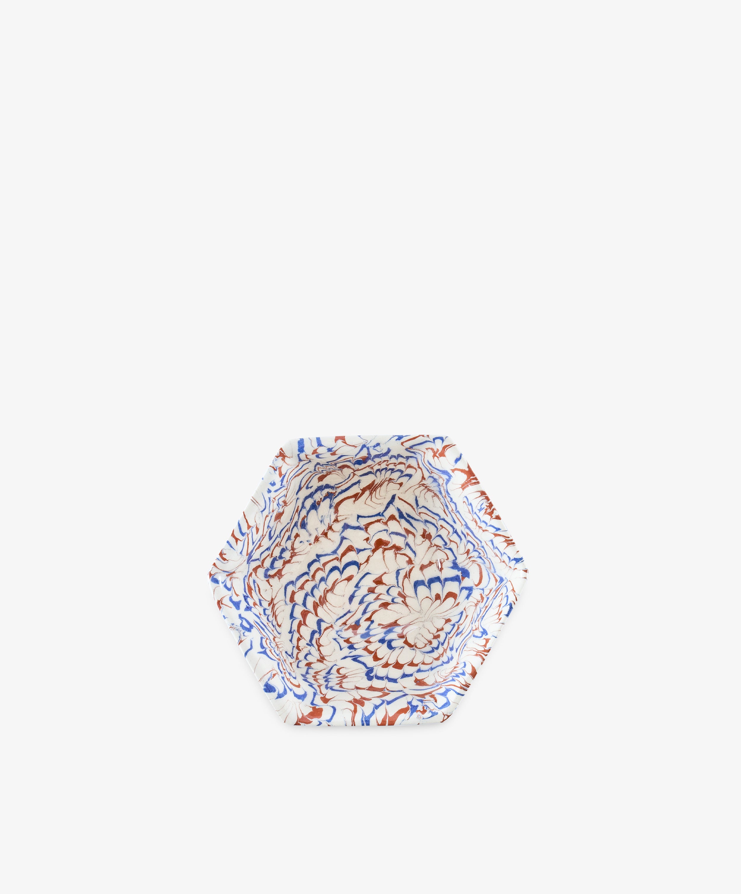 Introducing the Celine Snack Bowl: a hexagonal marbled ceramic bowl featuring a striking pattern in blue, red, and white on a crisp white background—perfect as an aperitivo bowl for serving small bites or as a unique Agateware accent for your table.