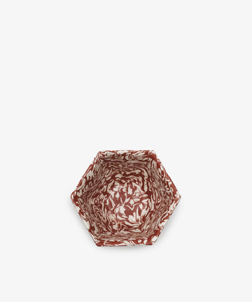 The Celine Snack Bowl features a hexagonal shape and a marbled red and white pattern, shown from above on a plain white background.