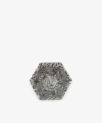The Celine Snack Bowl is a hexagonal handmade bowl with striking black and white marbled patterns, perfect for serving snacks. Shown set against a plain white background.
