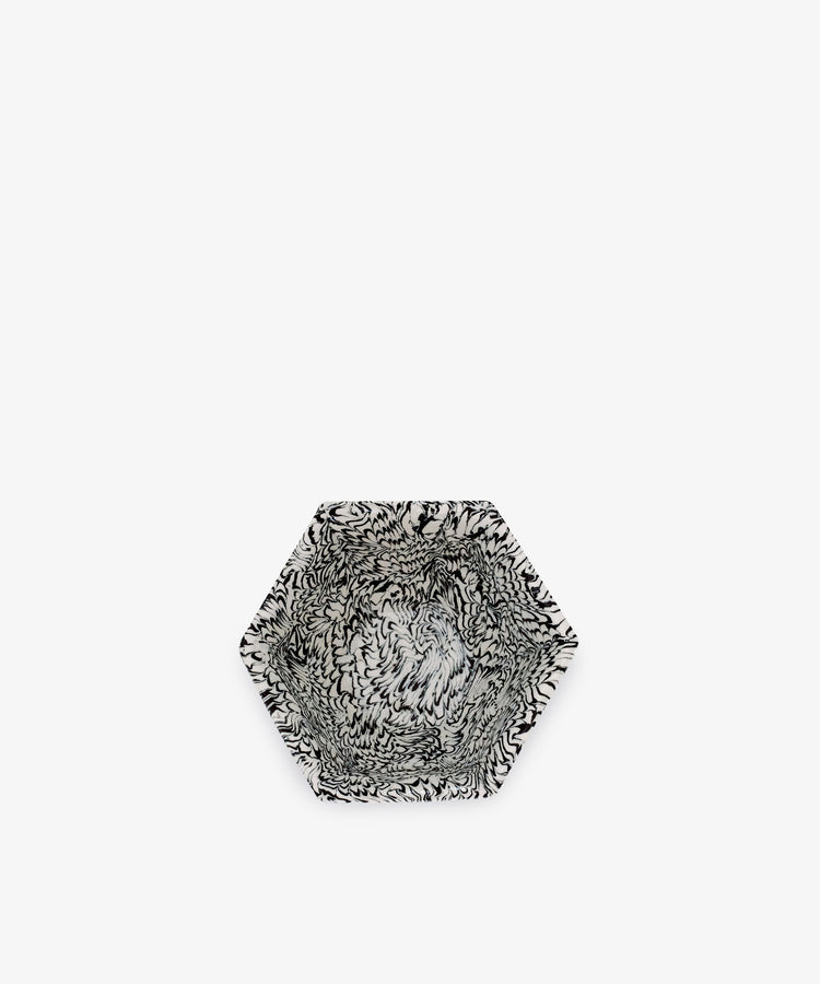 The Celine Snack Bowl is a hexagonal handmade bowl with striking black and white marbled patterns, perfect for serving snacks. Shown set against a plain white background.