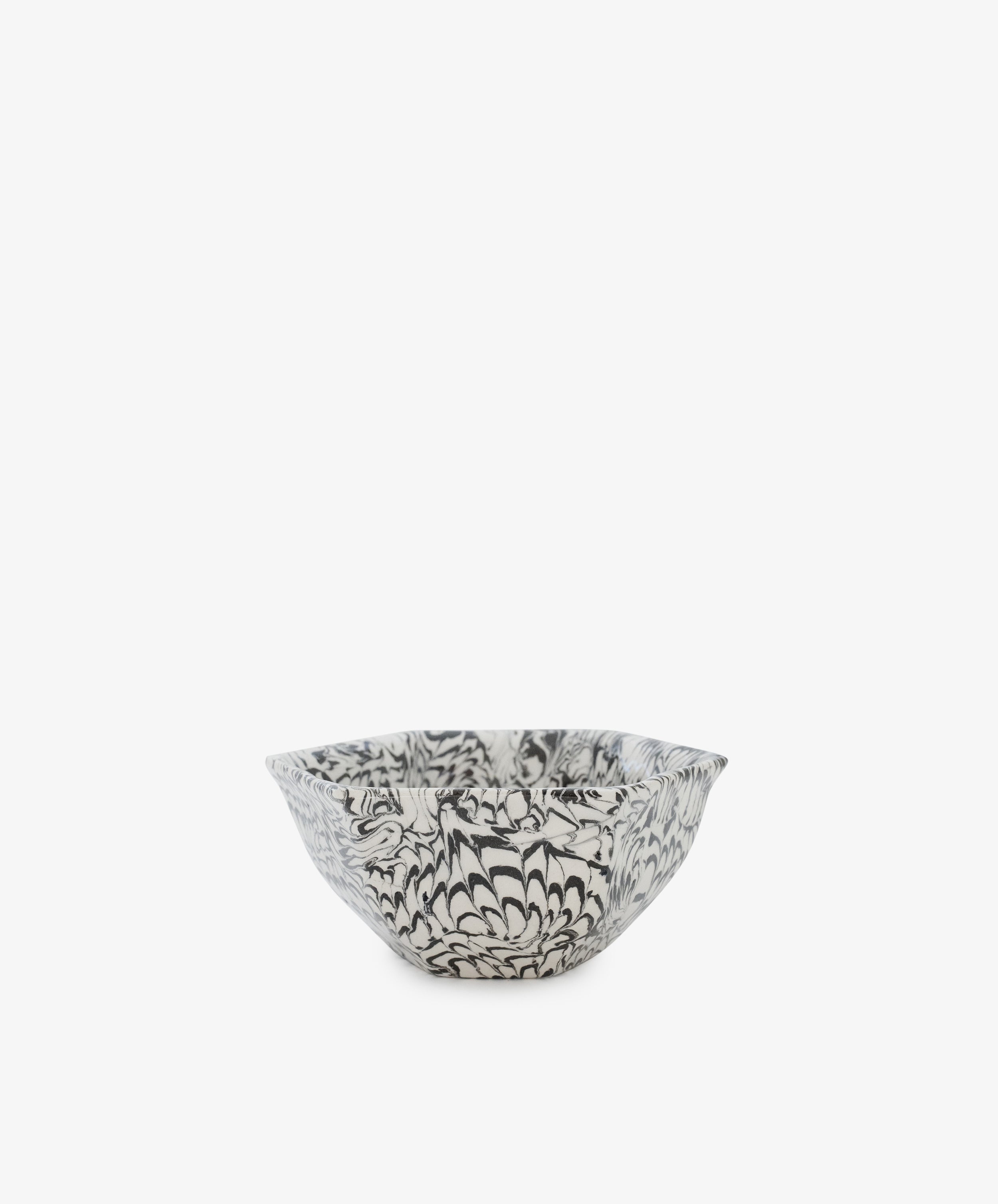 The Celine Snack Bowl is a small handmade bowl with a black and white floral pattern on a plain white background, perfect for snacking.