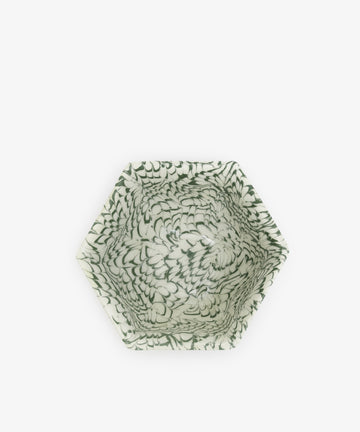 The Celine Snack Bowl is a handcrafted hexagonal ceramic bowl featuring a green, feather-like pattern on white, inspired by Aptware traditions—a unique marbled snack bowl viewed from above.