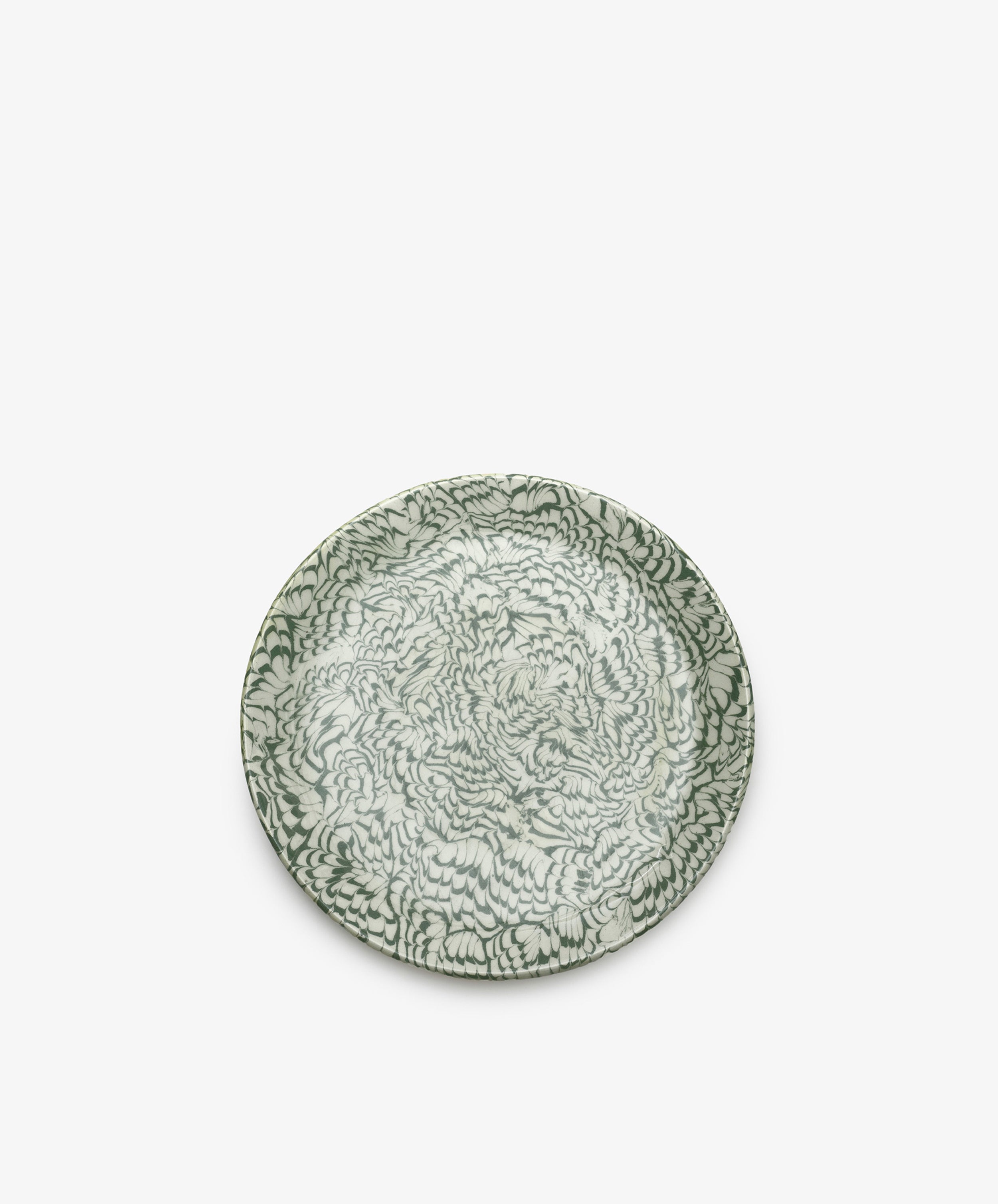 The Celine Serving Plate is a round, handcrafted ceramic platter featuring an intricate green and white floral pattern, beautifully photographed against a plain white background.