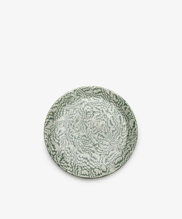 The Celine Serving Plate is a round, handcrafted ceramic platter featuring an intricate green and white floral pattern, beautifully photographed against a plain white background.