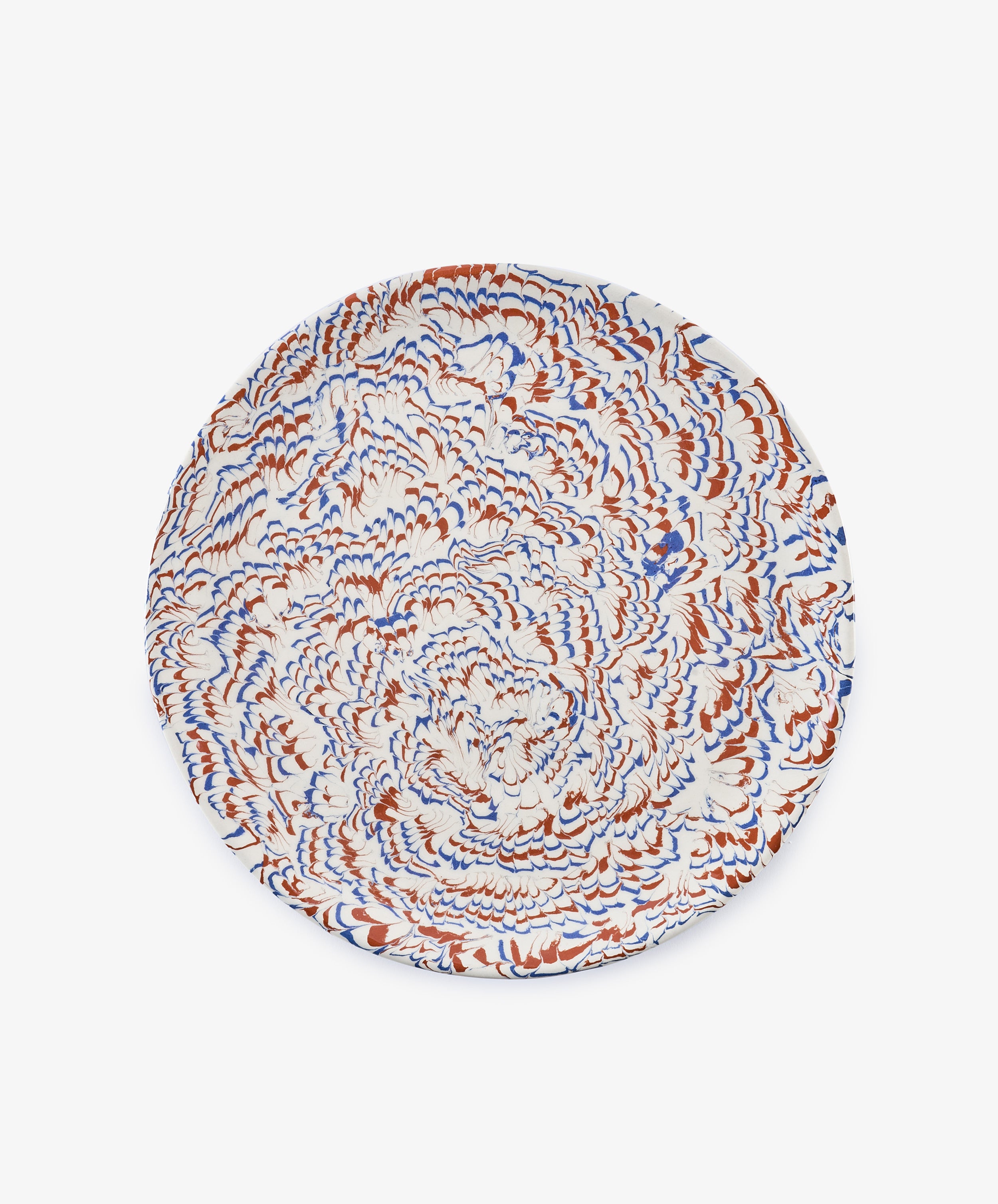 Round ceramic plate with a swirling marbled pattern in white, blue, and rust colors, viewed from above against a plain white background—this Celine Serving Platter beautifully showcases the artistry of marbled ceramics in a unique handmade serving dish.