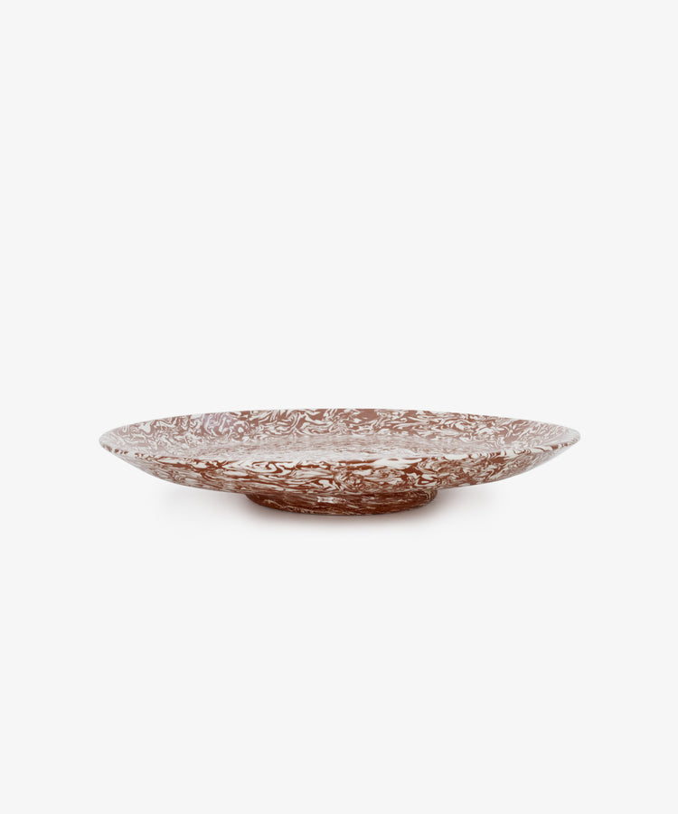 The Celine Serving Platter is a shallow, round ceramic plate featuring a marbled brown and white pattern, shown against a plain white background.