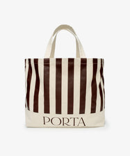 The PORTA Canvas Tote Bag is an oversized canvas tote with vertical brown and white stripes and PORTA printed in brown at the bottom.