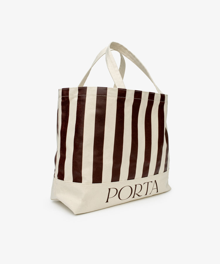 The PORTA Canvas Tote Bag features vertical brown and white stripes, double handles, and PORTA at the bottom edge—an oversized canvas tote ideal for carrying your daily essentials.
