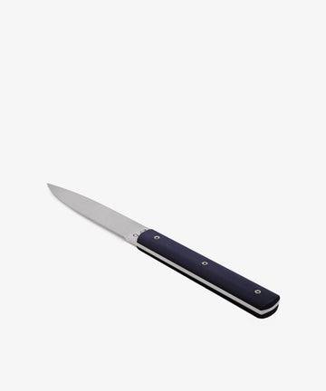 The 9.47 Table Knife, featuring a straight stainless steel blade and dark handle, is displayed diagonally on a white background.