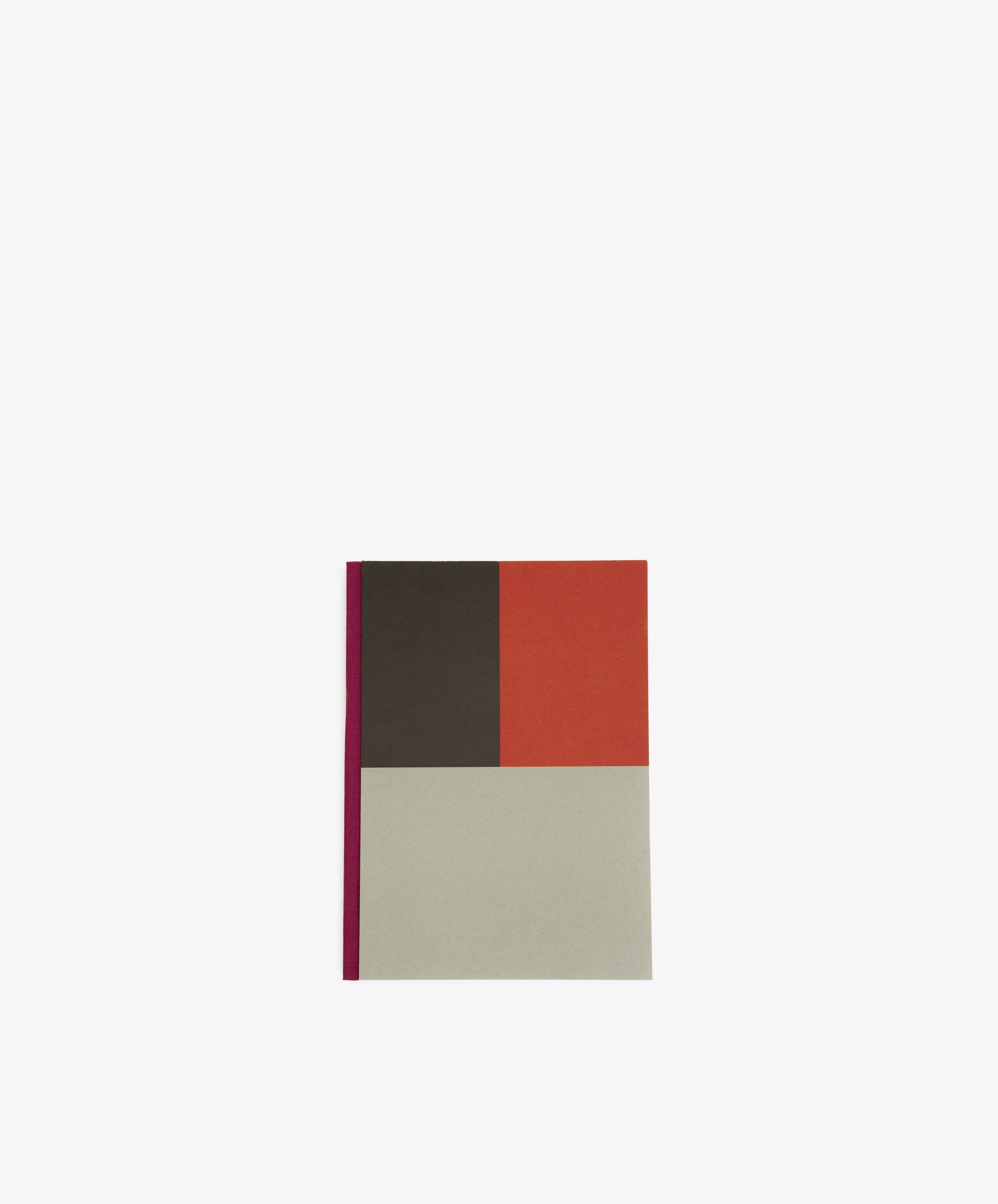 The Dreamer's Notebook features a chic geometric color block cover in dark brown, red, and light gray with a magenta spine—perfect for jotting down thoughts. Shown centered on a white background.