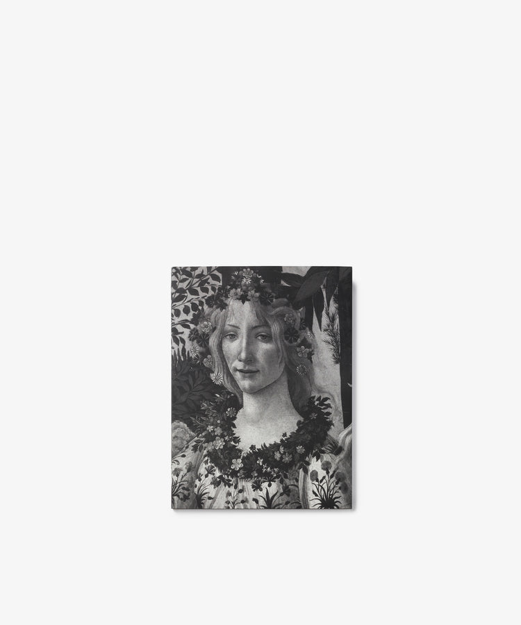 Black and white image of Botticelli, a classical painting reminiscent of Renaissance art, featuring a woman adorned with flowers in her hair and around her neck, set against a leafy background evocative of Primavera.