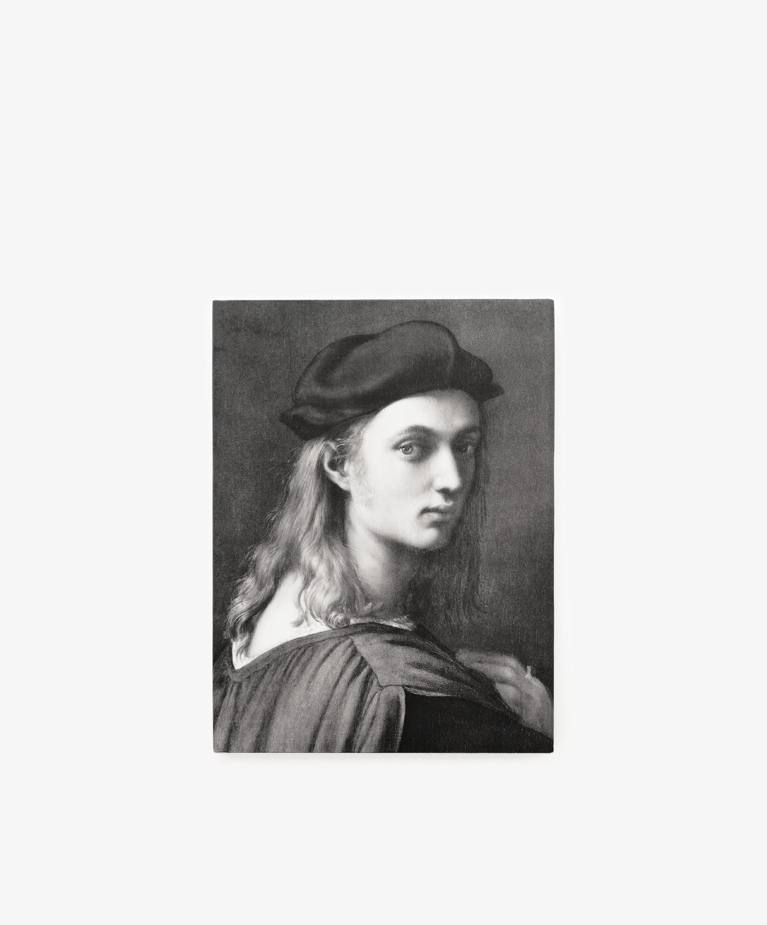 Black and white portrait of a person with long hair wearing a dark beret and cloak, gazing over their shoulder against a plain background—capturing the timeless elegance of the High Renaissance as exemplified by Raphael, celebrated in the Phaidon Classics volume 