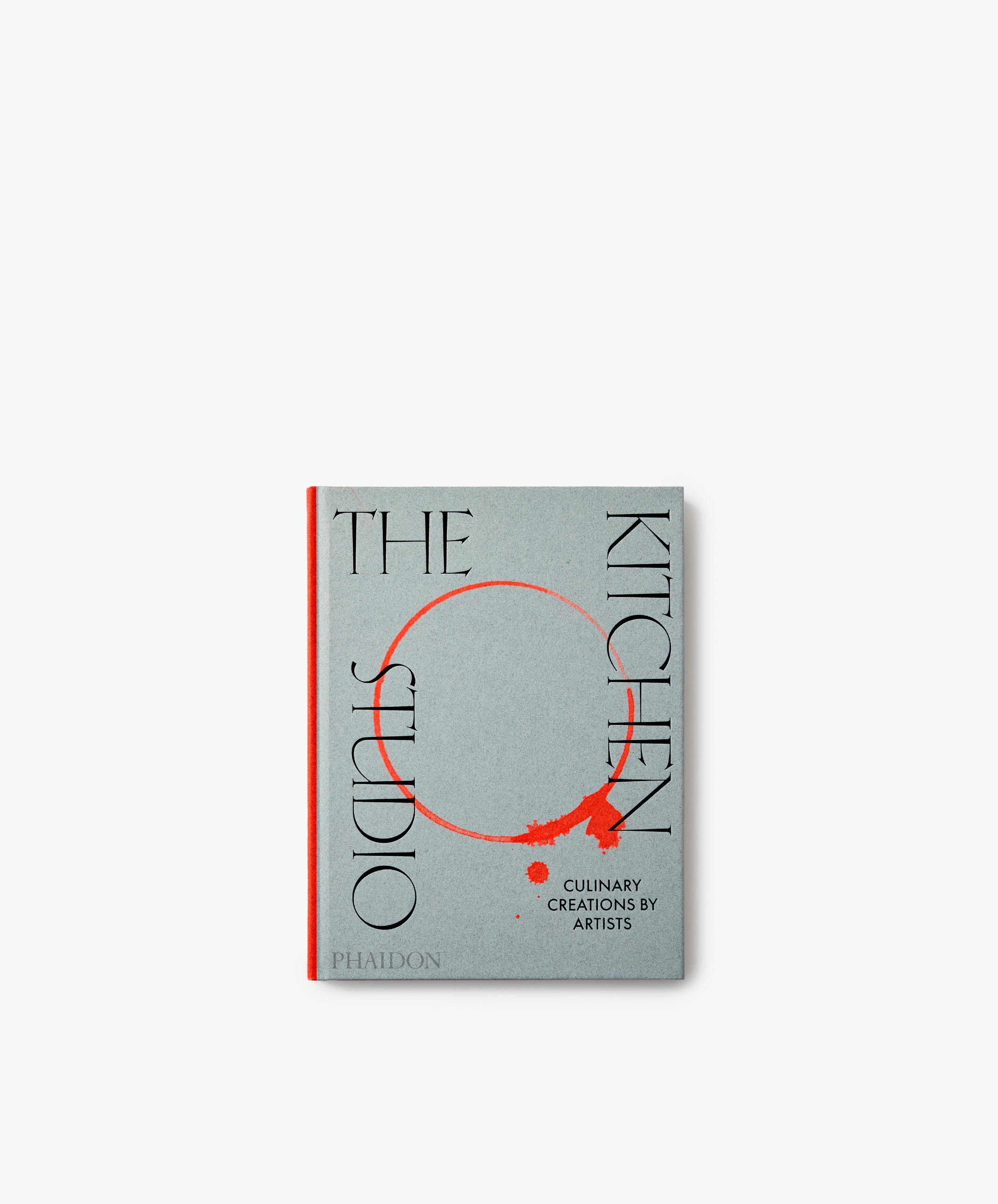 The Kitchen Studio: Culinary Creations by Artists is a gray art cookbook featuring black and red text with a red circular design on the cover, offering unique recipes crafted by contemporary artists.