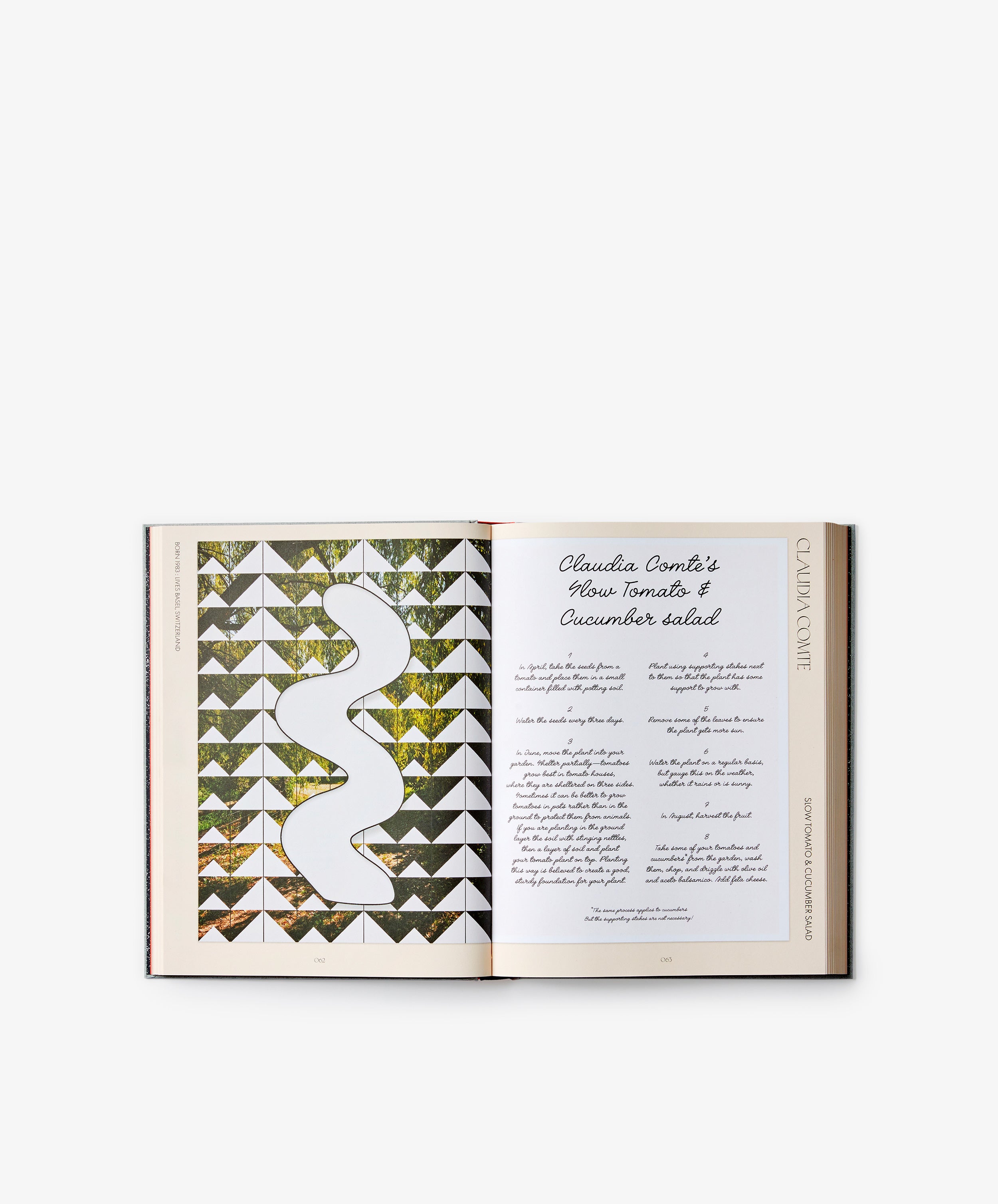 An open copy of The Kitchen Studio: Culinary Creations by Artists displays a geometric-artwork page on the left and a handwritten recipe for Claudia Conte’s Heirloom Tomato & Cucumber Salad on the right—a vivid blend of contemporary artistic expression and distinctive artist-driven recipes.