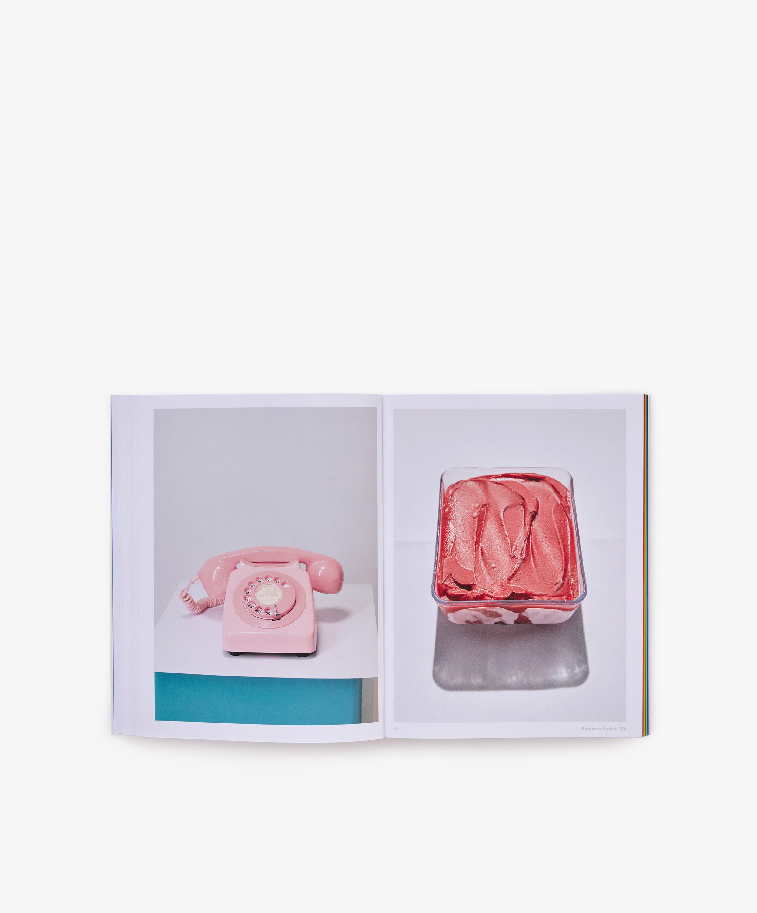 Open book displaying two photos: on the left page, a pink rotary phone sits atop a table; on the right, there's a container brimming with pink ice cream. The crisp white background creates a fresh, modern vibe—mirroring the iconic aesthetic of *The River Cafe Look Book: Recipes for Kids of all Ages*, renowned for its accessible recipes perfect for cooks at any level.